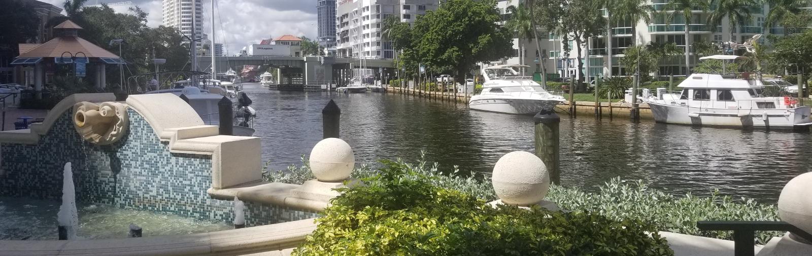 Boats in canal with city.